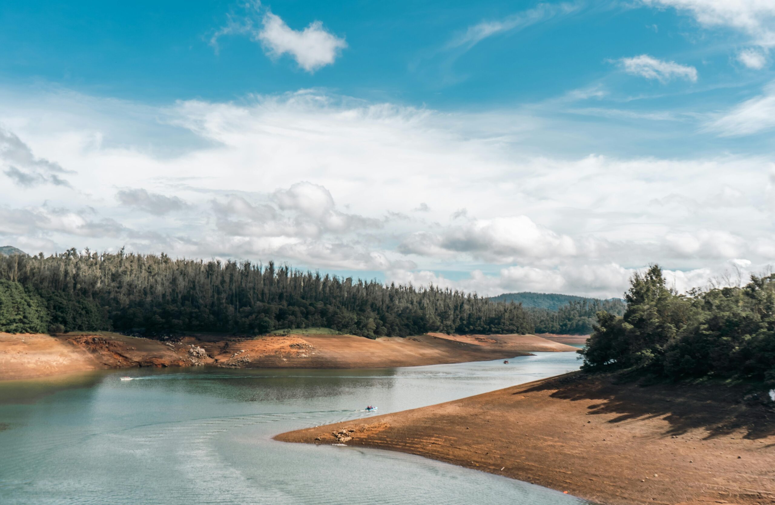 Landscape of a River between Trees and Mountains in Distance