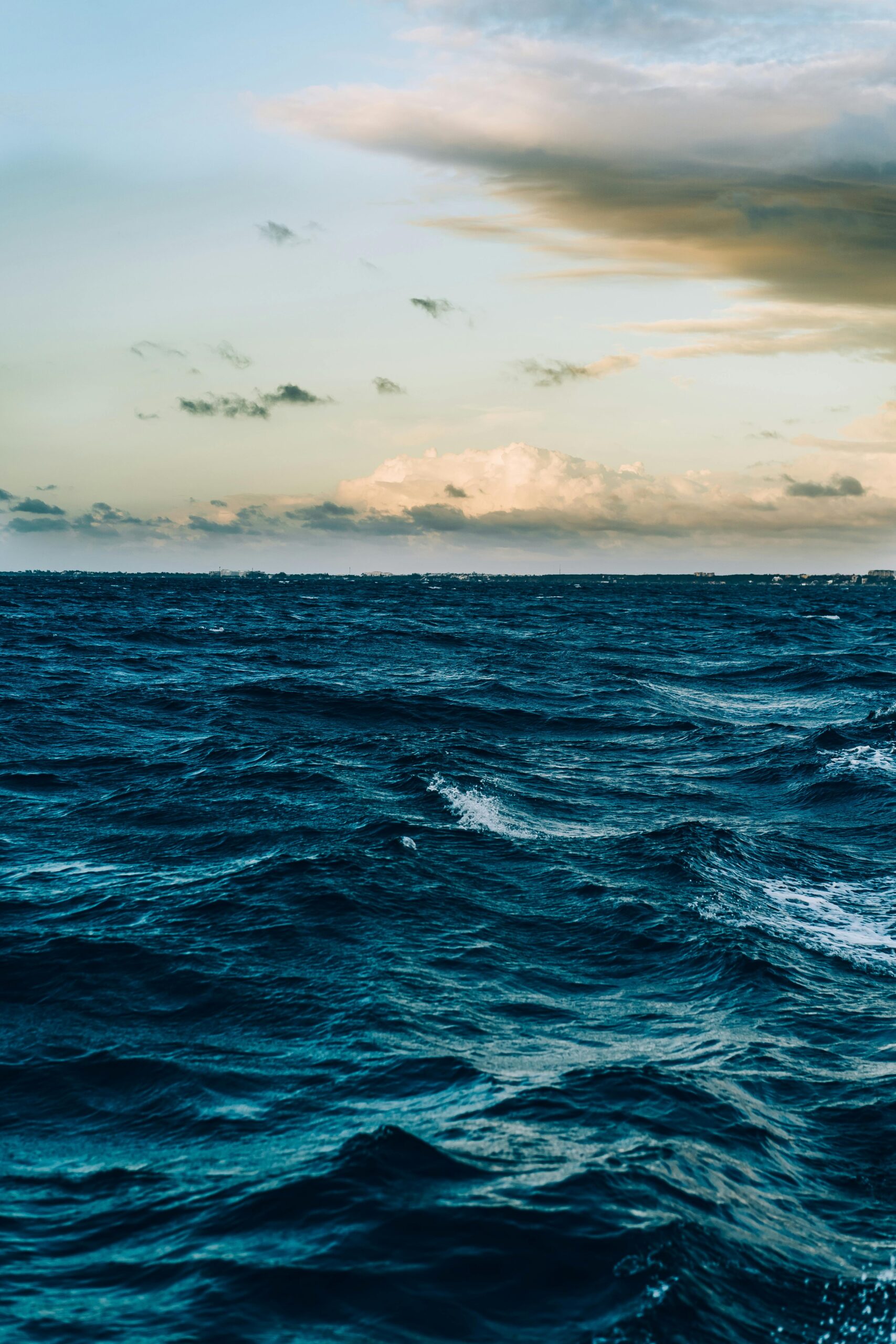 A captivating view of ocean waves under a dramatic twilight sky, offering a peaceful seascape.