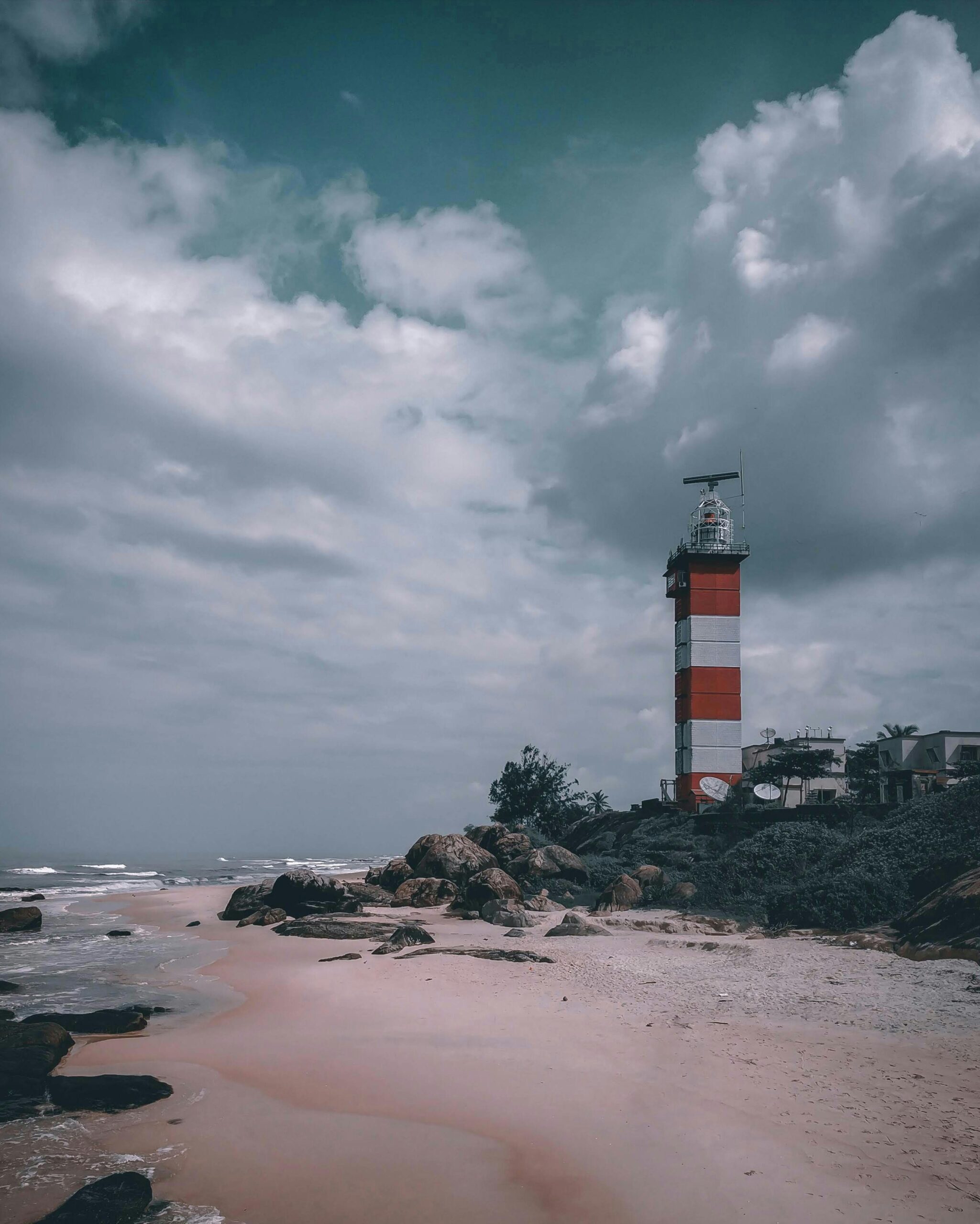 Picturesque lighthouse on a cloudy day at Mangalore beach, capturing a serene coastal atmosphere.